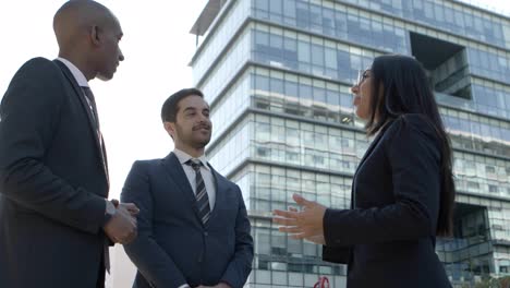 business people meeting and talking on street