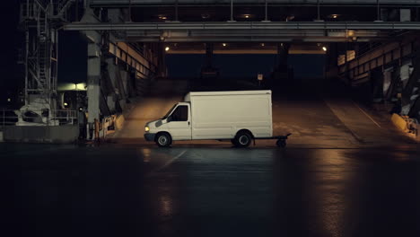 white box truck on a ferry ramp at night
