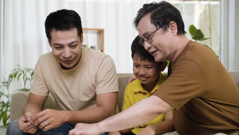 asian men and boy in the living room