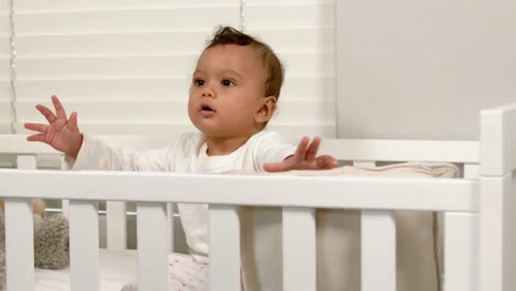 cute baby sitting in his crib