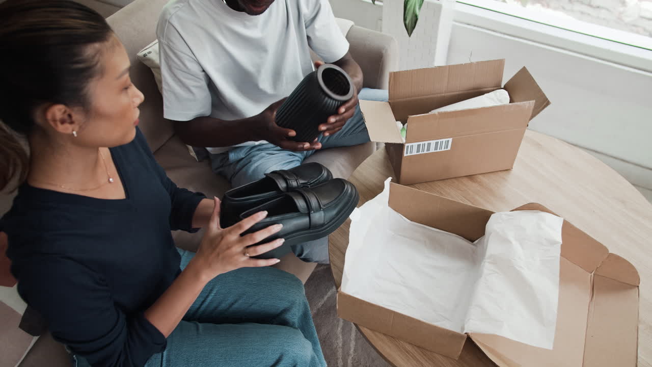 Couple Opening Parcels with Shoes and Vase Bought Online