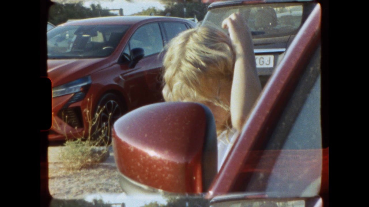Niña mirando por la ventana del coche en un estacionamiento