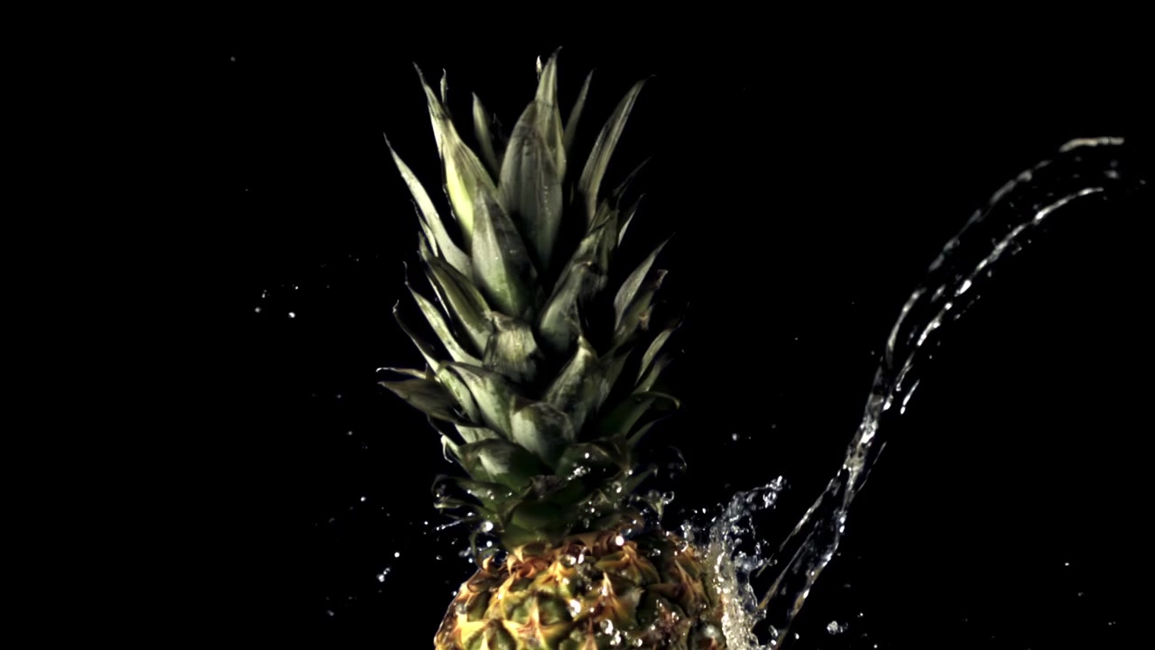 Fresh Pineapple with Water Splashing on Black Background