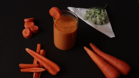 fresh-squeezed carrot juice on black background