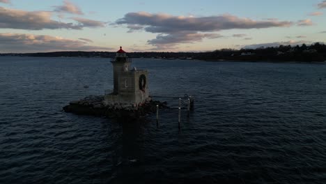 an aerial view of the huntington harbor lighthouse on long island, ny at sunset, with a christmas wreath