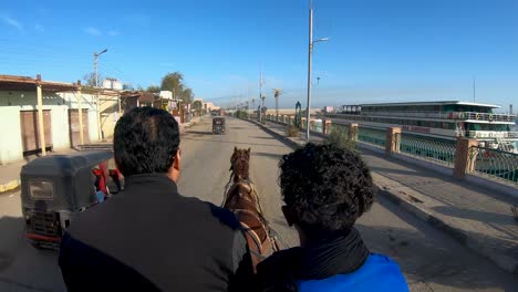 riding a horse in a carriage