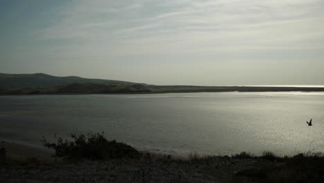 view of river afon dwyryd from portmeirion village with hills in background