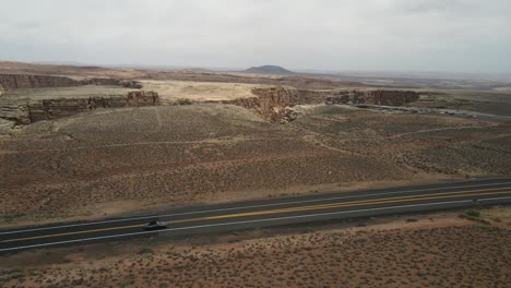 drone aerial cinematic shot with a tracking effect following a mustang car along route 66