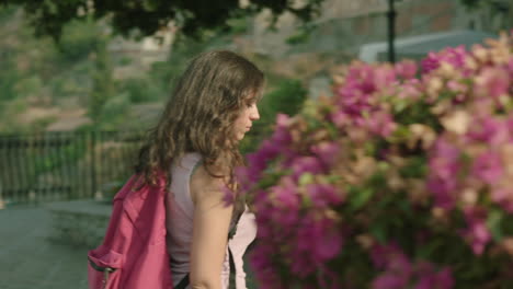 attractive caucasian ethnicity young woman tourist walking past camera looking for something