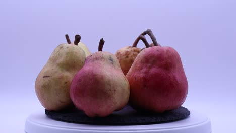 fresh ripe red pear rotating on a turntable