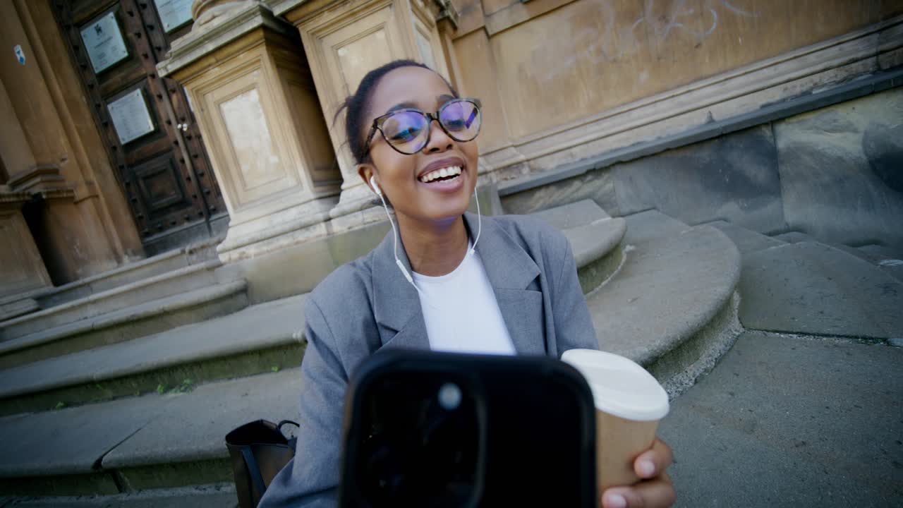Young woman taking a selfie on city stairs