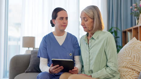 nurse assisting elderly woman with tablet