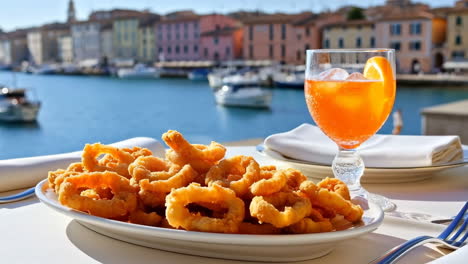 fried calamari and aperol spritz by a scenic european waterfront