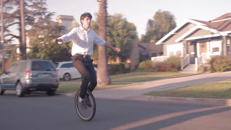 unicyclist on a suburban street