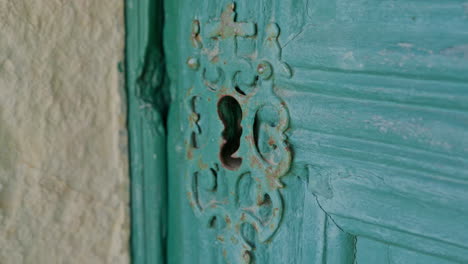 antique church door lock with a metal pattern with a cross close up