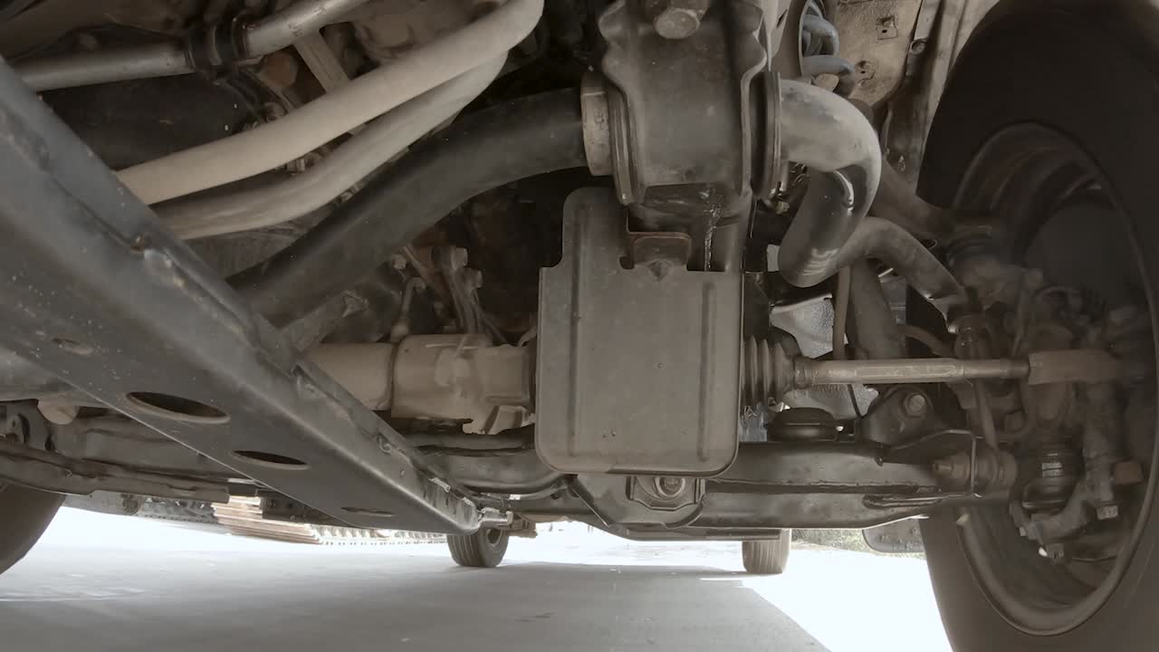 View under the pickup truck is running.