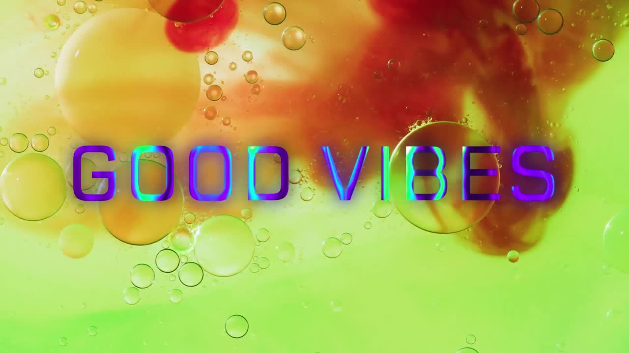 Animation of good vibes text over close up of liquid and baubles