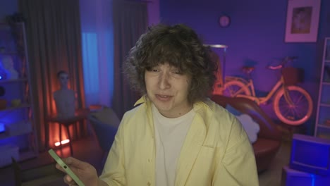 man streaming on smartphone in home studio