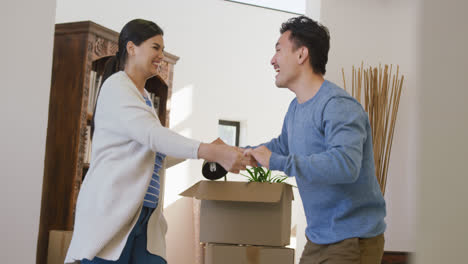 video of happy diverse couple danging with joy in new house