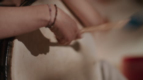 person playing a traditional drum