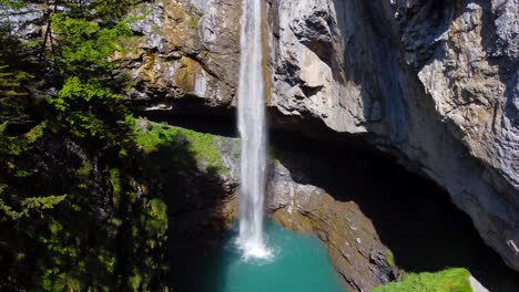 Aerial-Rising-Shot-of-Berglistüber-Waterfall-in-Switzerland