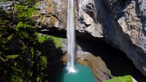 aerial rising shot of berglistüber waterfall in switzerland