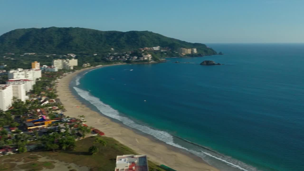 DRONE: PANNING SHOT OF THE BEACH OF IXTAPA AT SUNSET