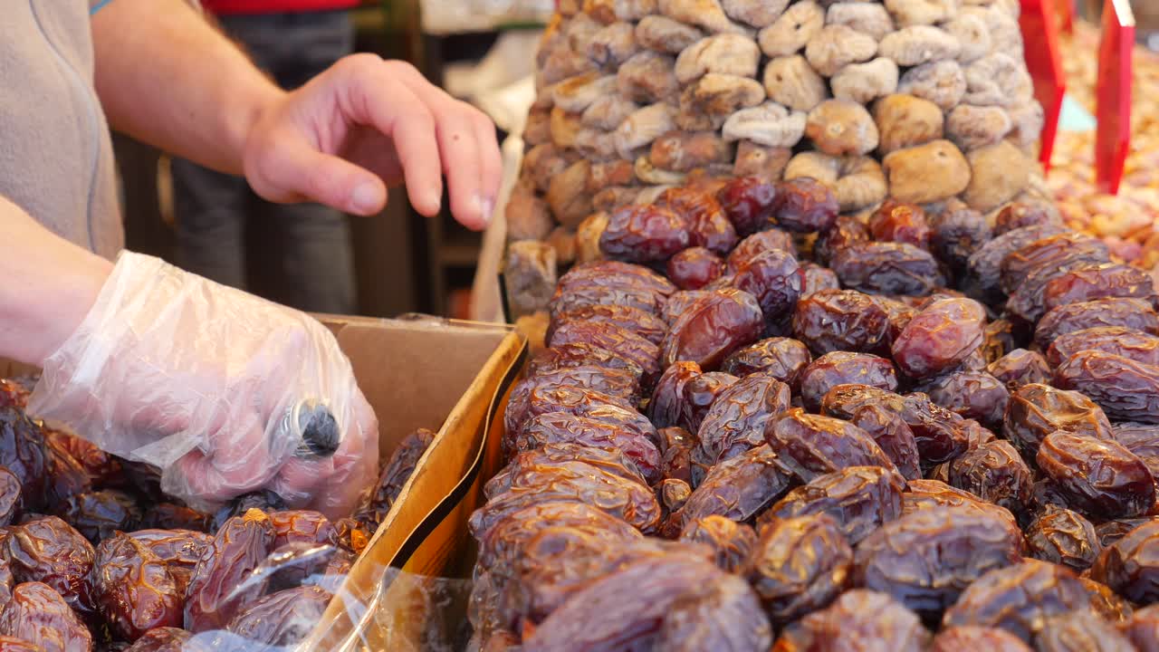 A vendor selling dates and figs at a market