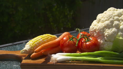 Pan-across-a-colorful-display-of-freshly-washed,-ripe-vegetables-in-the-sunlight