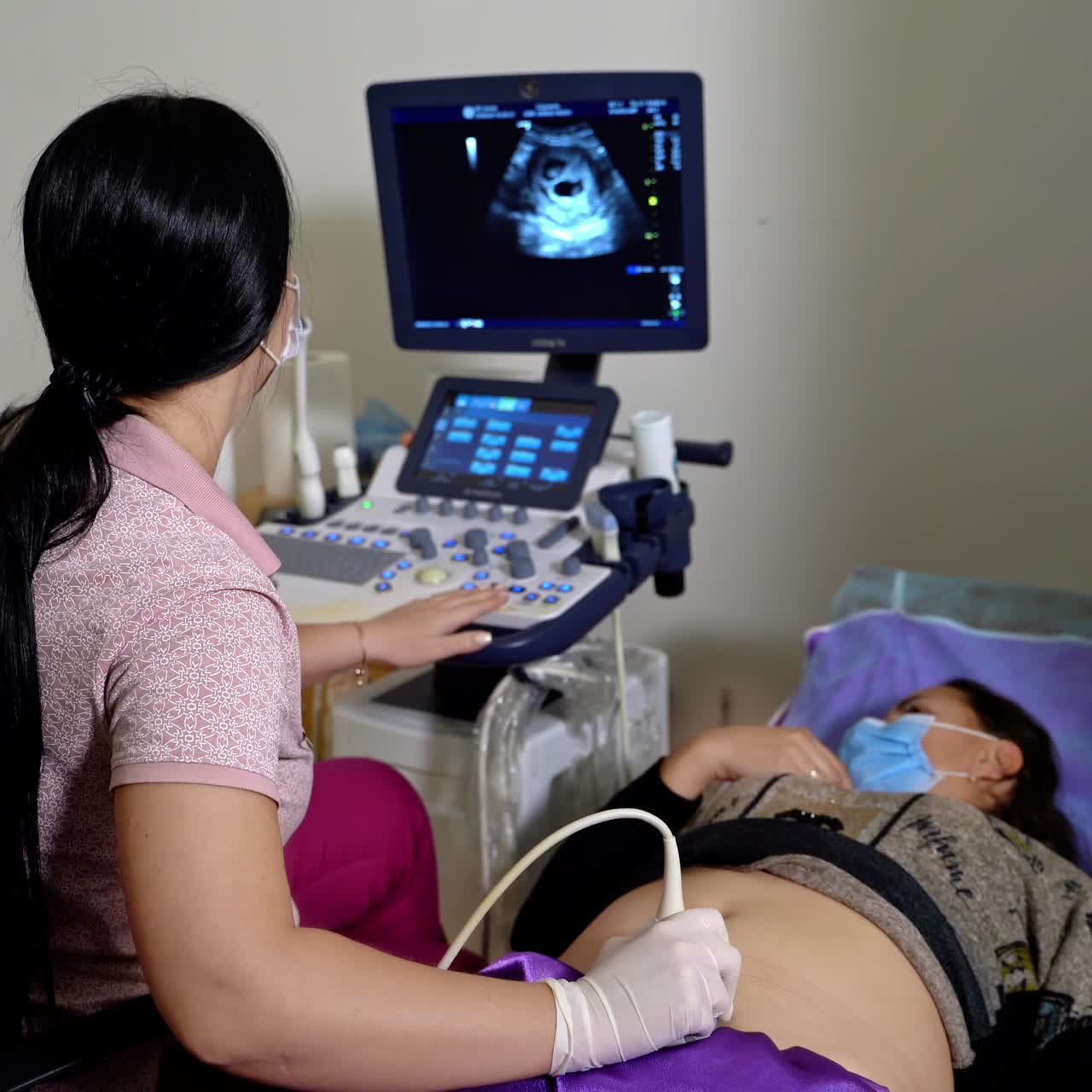 Little boy undergoing ultrasound scan in modern clinic. Kid having abdominal ultrasound examination at hospital. Pediatric concept