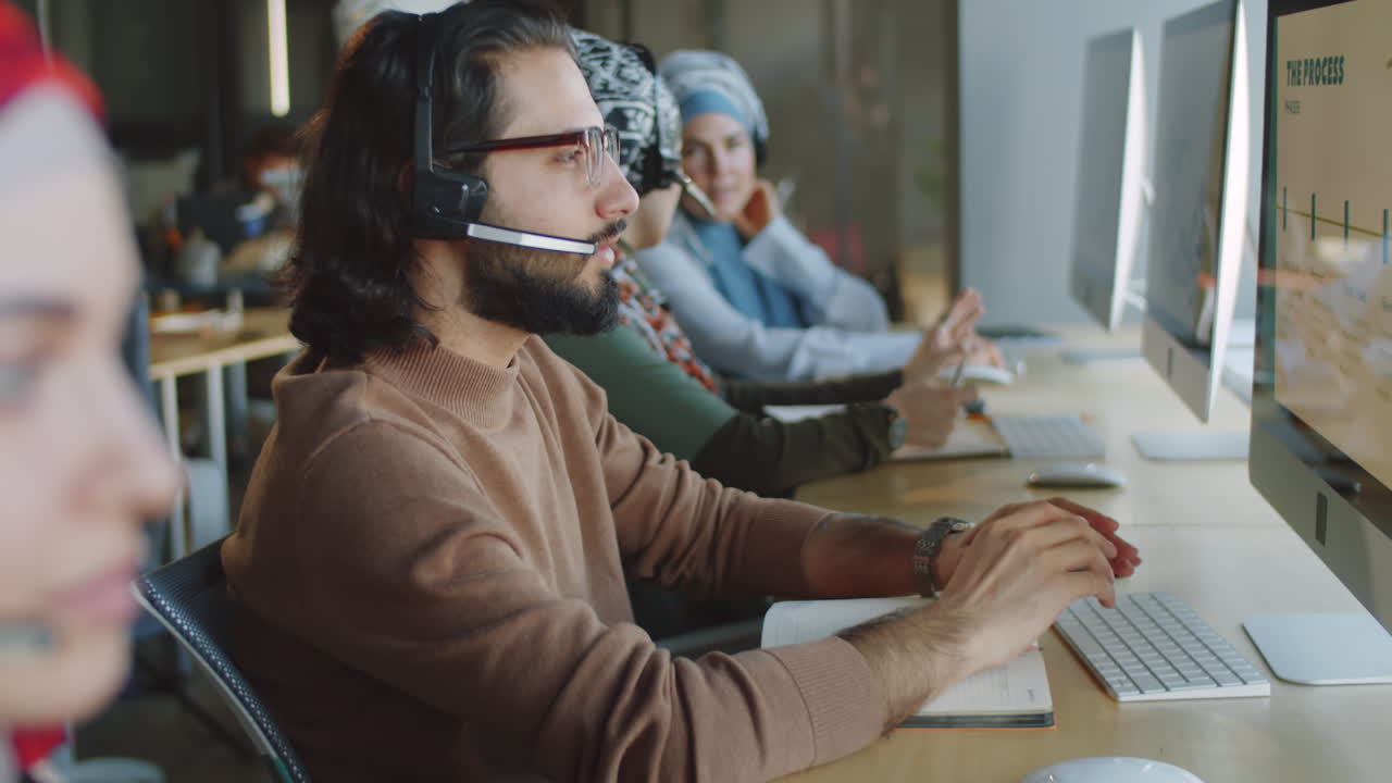 Middle Eastern Male Agent in Headset Working in Support Center
