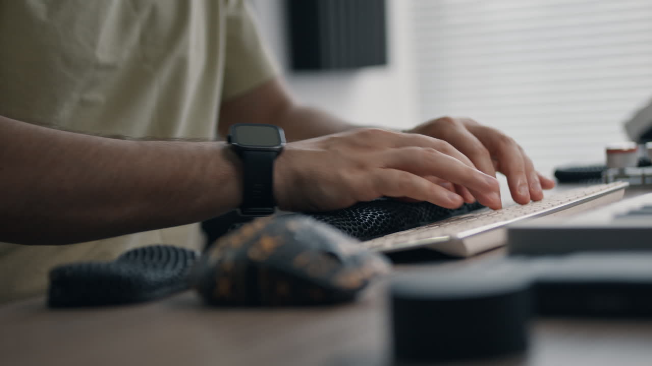 Man working on computer in a music production studio.