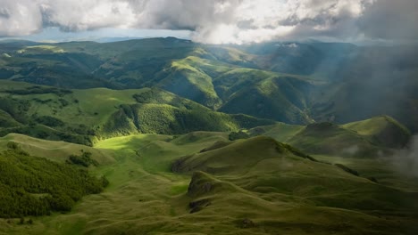 Low-clouds-over-a-highland-plateau-in-the-rays-of-sunset.-Sunset-on-Bermamyt-plateau-North-Caucasus,-Karachay-Cherkessia,-Russia.