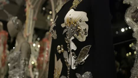 ornate black couture dress with embellishments on display