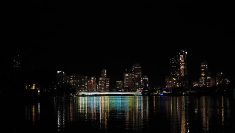 city lights reflecting on water at night