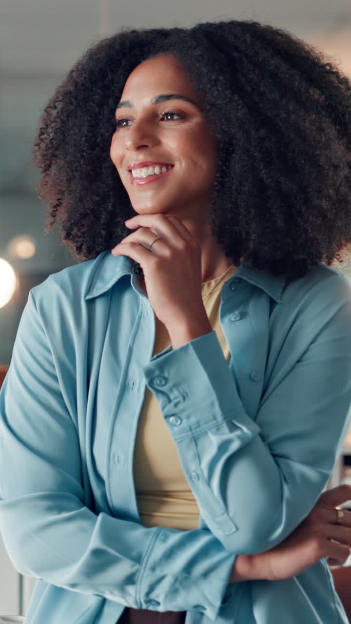 Young Woman with Curly Hair Smiling and Looking Away Thoughtfully