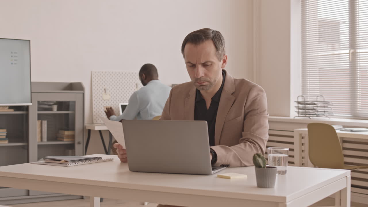 Caucasian Businessman Working at Desk