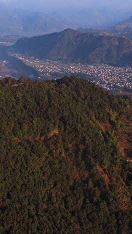 vertical aerial tilting over sarangkot hills, revealing the snowy peaks of nepal