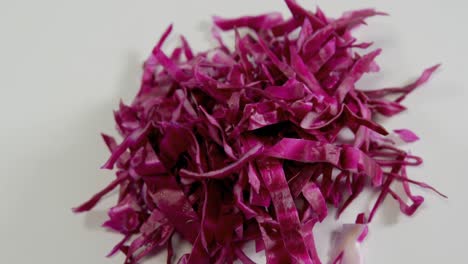 Shredded-red-cabbage-on-white-background-4K-4k