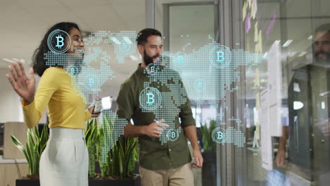 discussing cryptocurrency over digital world map, colleagues in modern office working