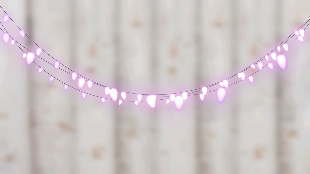 animación digital de luces de hadas decorativas rosadas colgando contra un fondo de madera