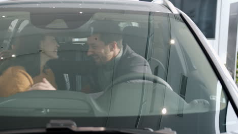 happy couple choosing a new car