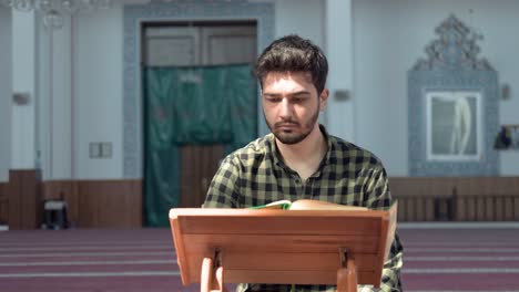 Muslim-Man-Reading-Quran-In-Mosque