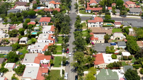 aerial view of a suburban residential street with houses and trees