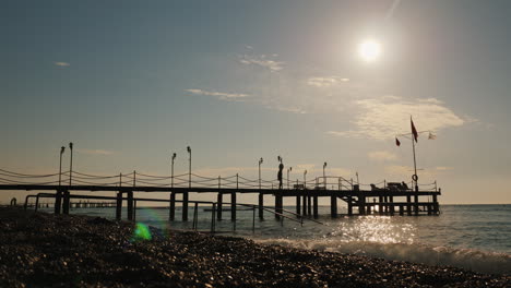 pier on the turkish shore on the flagstaff turkish flag early morning at the sea 4k video