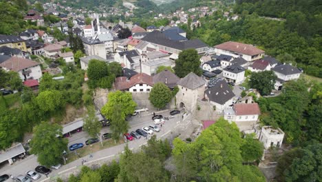 aerial view of cars driving through travnik gate in jajce, bosnia and herzegovina