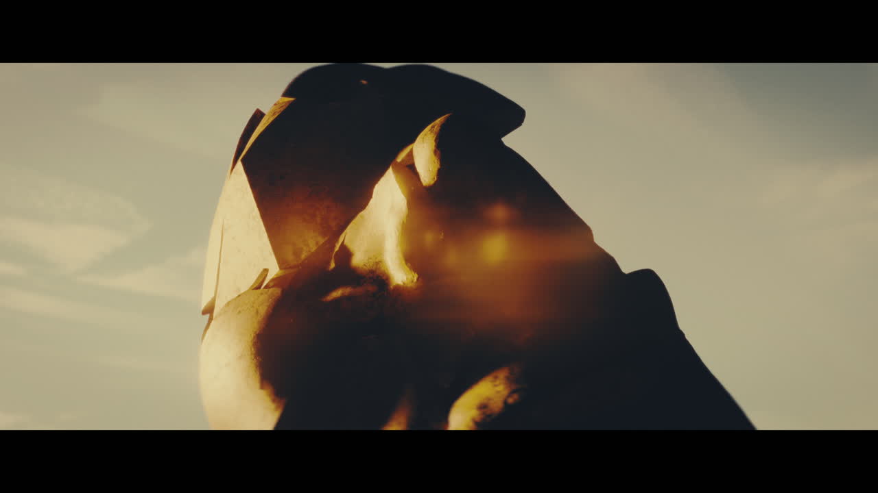 Huge golden statues in the desert during sunset