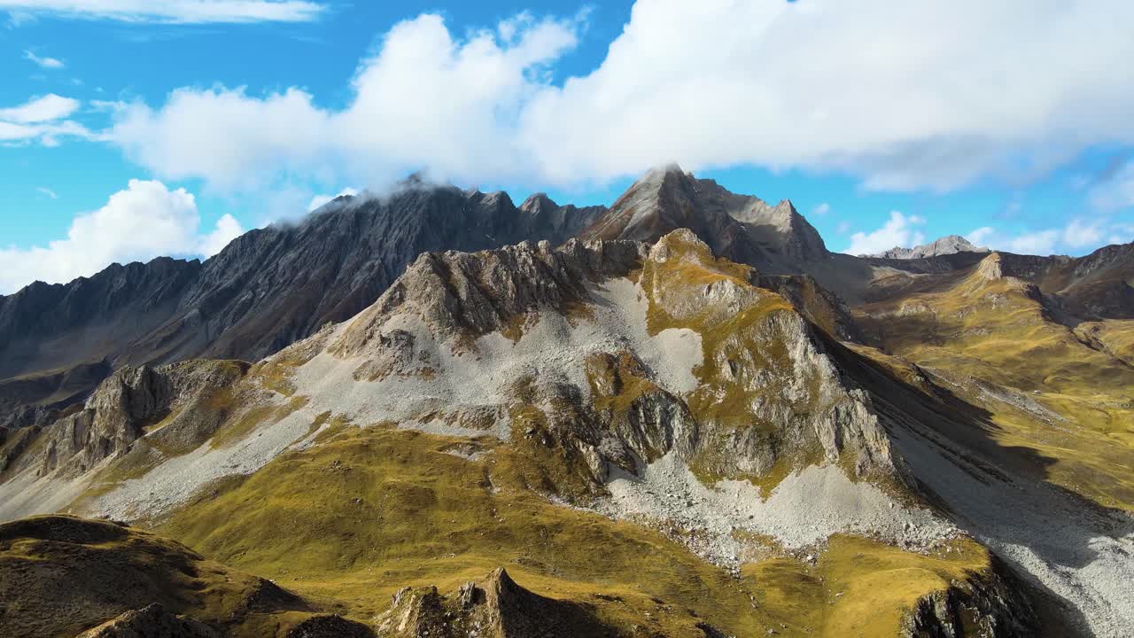 Aerial landscape of La Plagne - Tarentaise, France. Mountains peaks. Famous travel destination at 2000 m altitude. Autumn landscape. Drone going foeward.