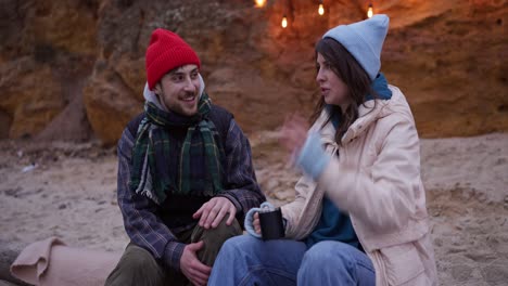 couple enjoying a conversation on a winter beach