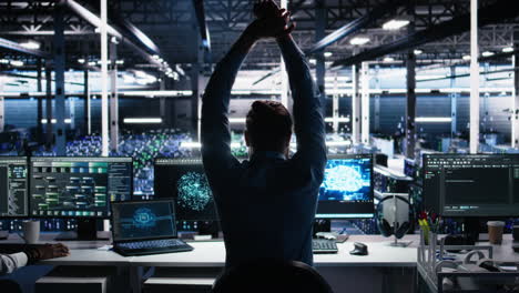 server room technician stretching sore back while using ai at desk